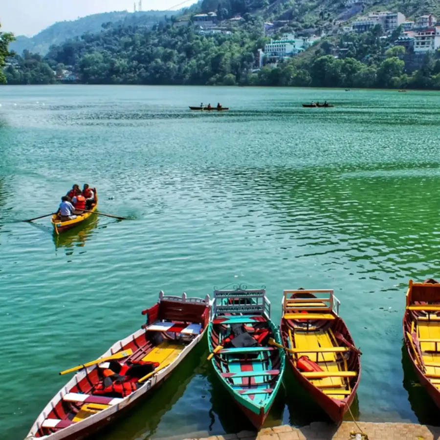 Boats on Bhimtal Lake surrounded by hills