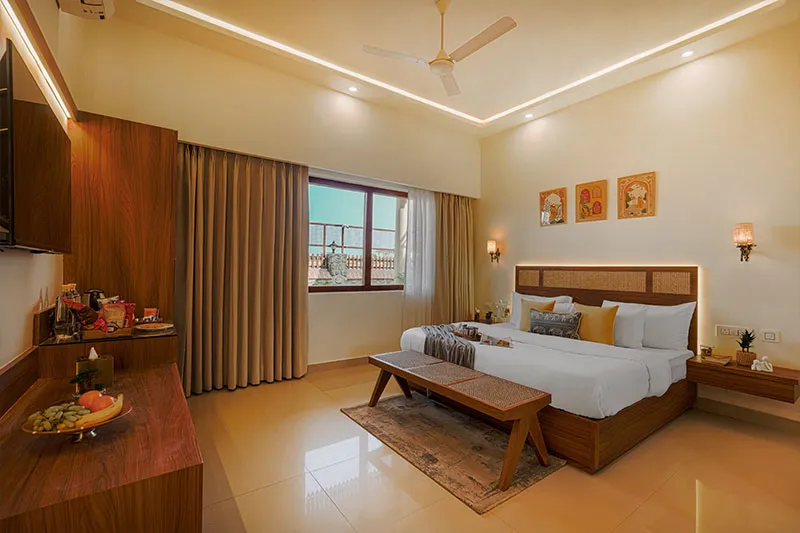 Deluxe Room bedroom with TV unit and wardrobe at Manovan Resort