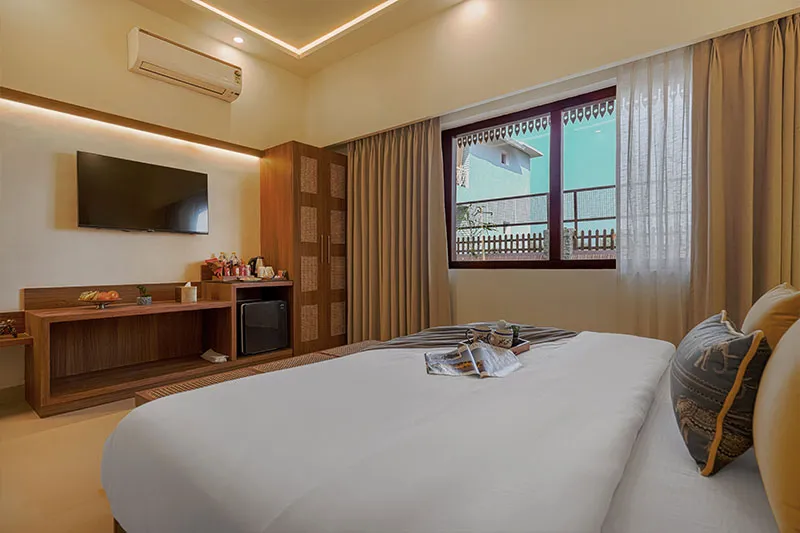 Deluxe Room seating nook with wardrobe and dresser