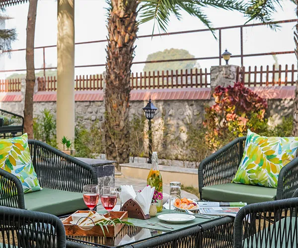 Outdoor lounge seating with wine glasses - Manovan Resort