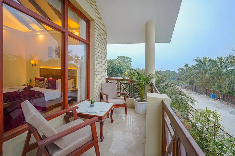Premium room private balcony seating with garden view