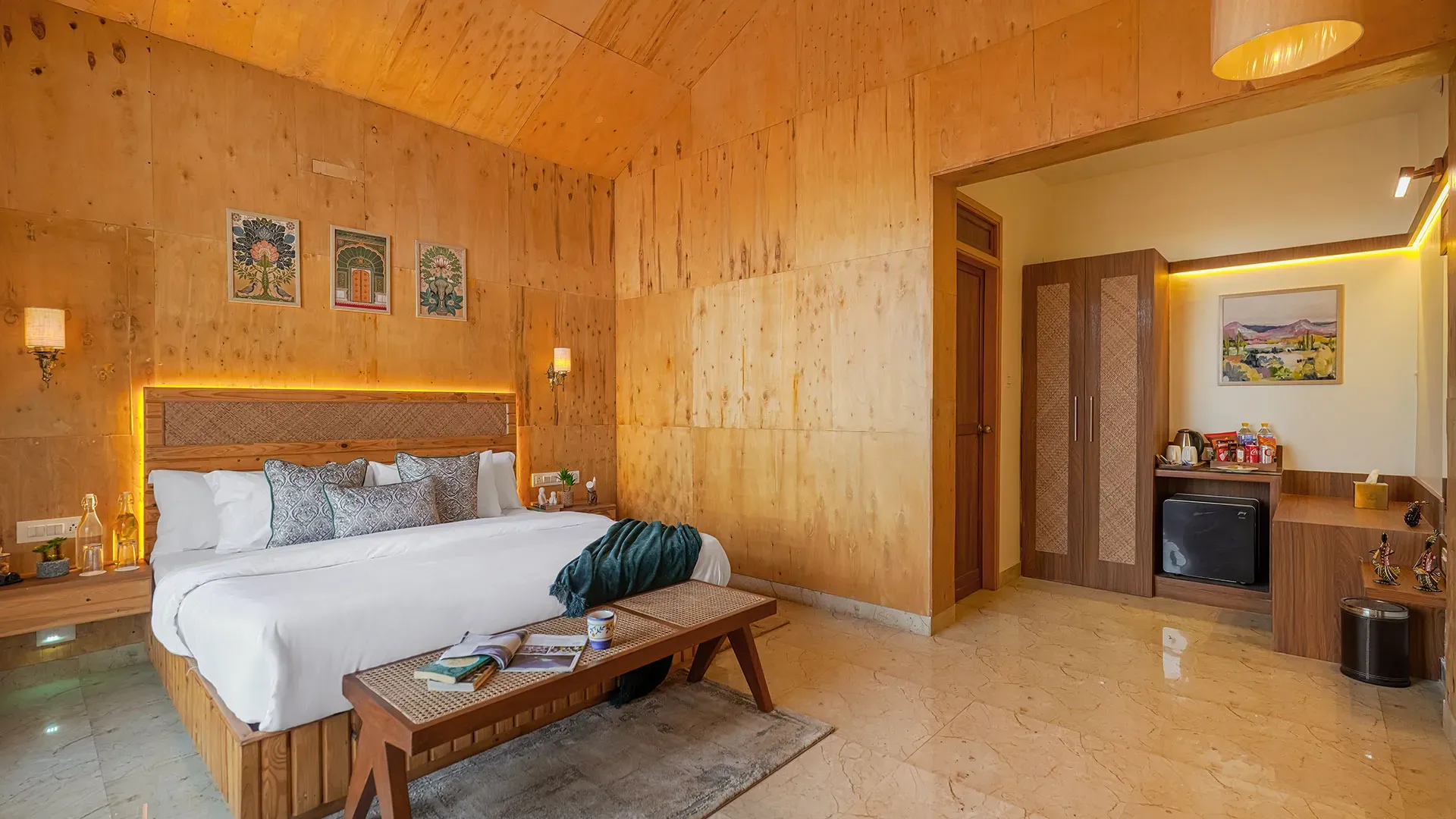 Wood-panelled cottage bedroom with king bed at Manovan Resort